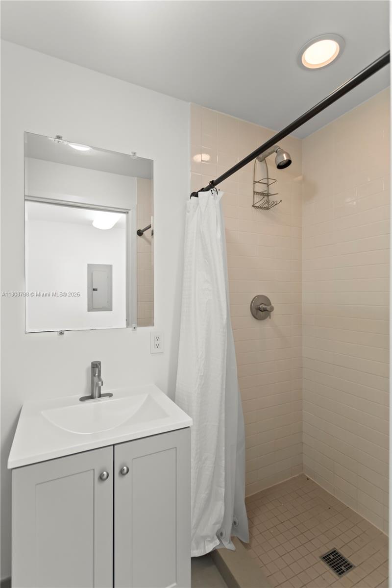 350 Ocean Drive, Unit 904N Key Biscayne, FL 33149 - Photo 13 of 41 a bathroom with a sink a vanity a mirror and shower