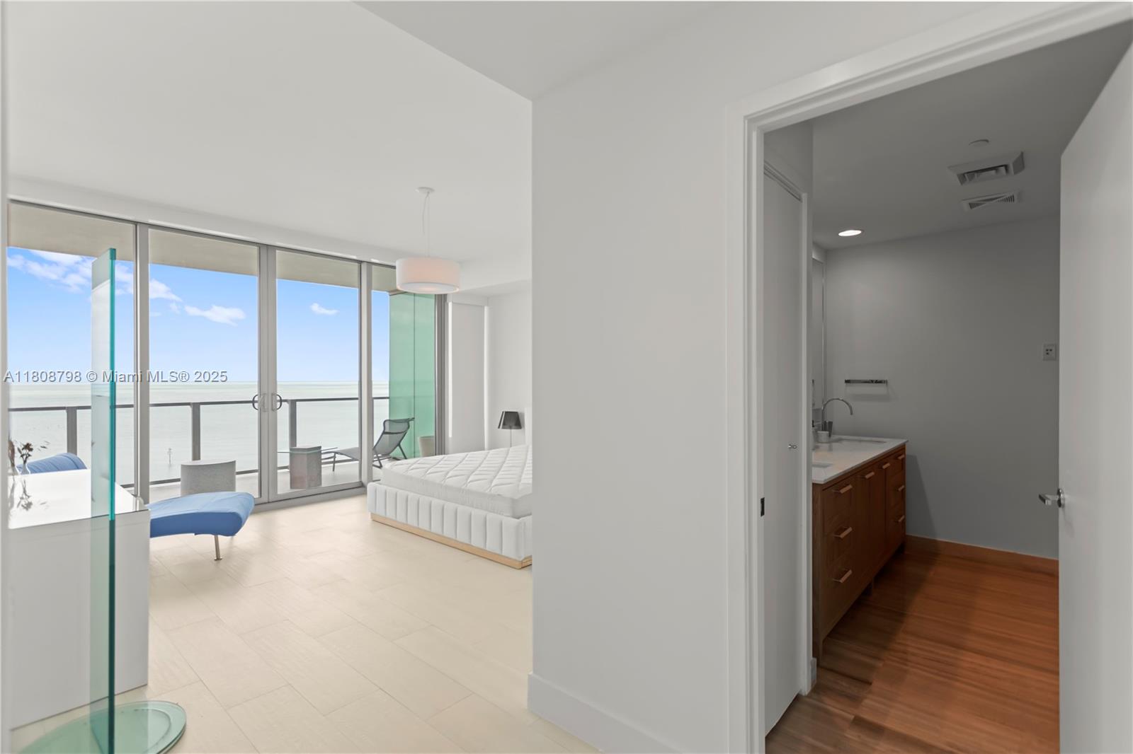 350 Ocean Drive, Unit 904N Key Biscayne, FL 33149 - Photo 23 of 41 a spacious bedroom with a balcony a bed and a large window