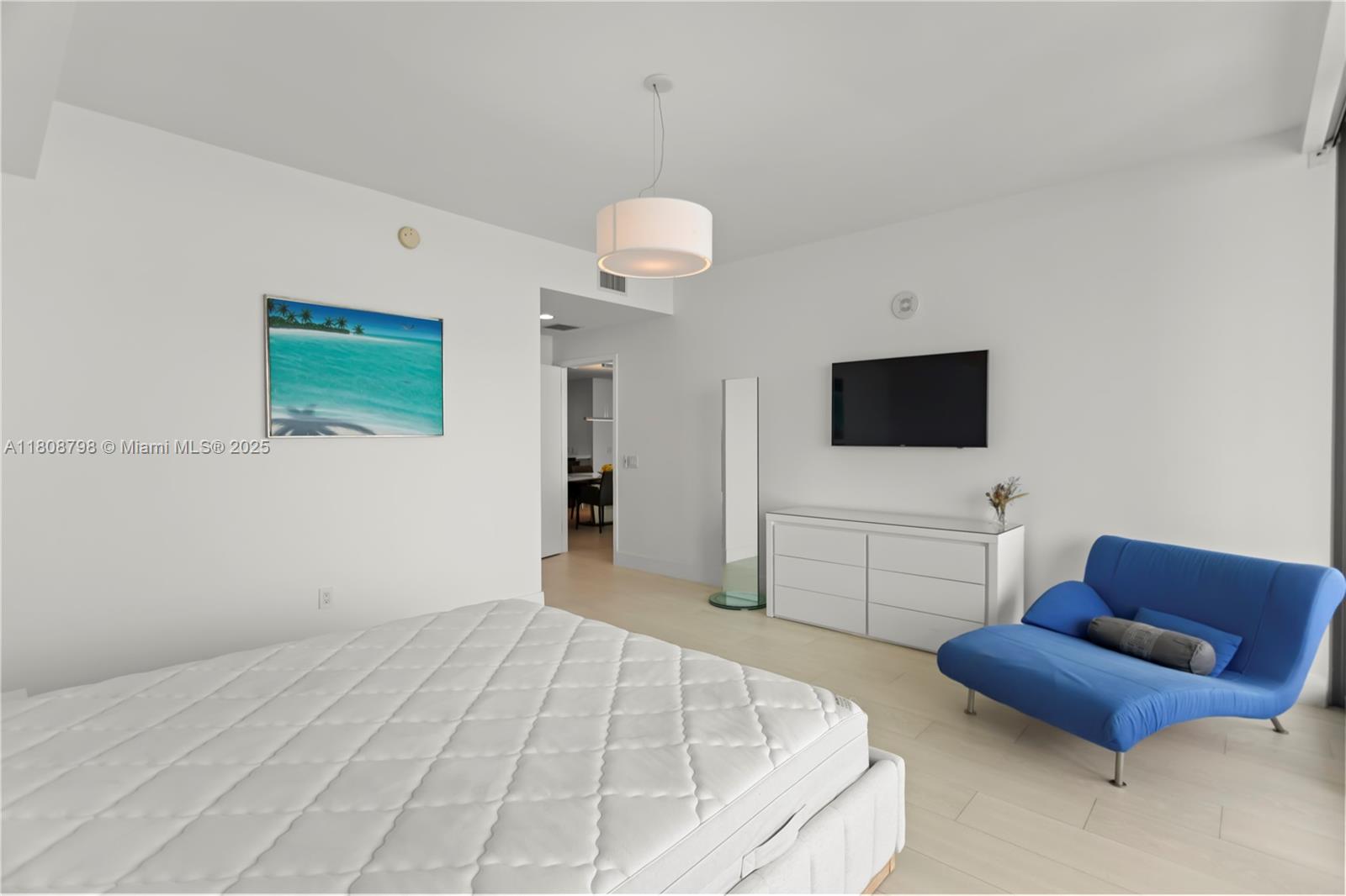 350 Ocean Drive, Unit 904N Key Biscayne, FL 33149 - Photo 25 of 41 a bedroom with a bed and a flat screen tv