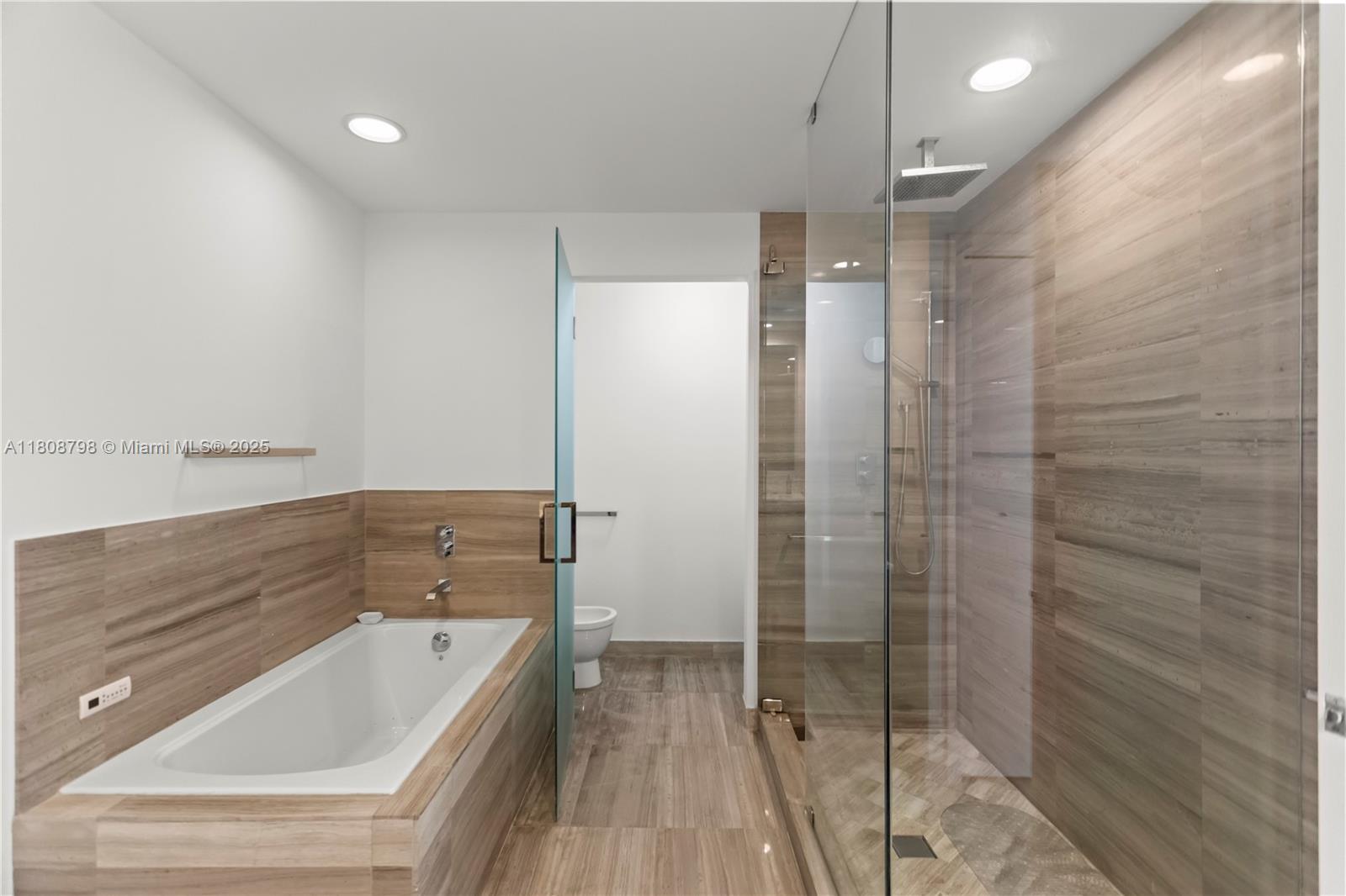 350 Ocean Drive, Unit 904N Key Biscayne, FL 33149 - Photo 28 of 41 a bathroom with a tub shower and sink