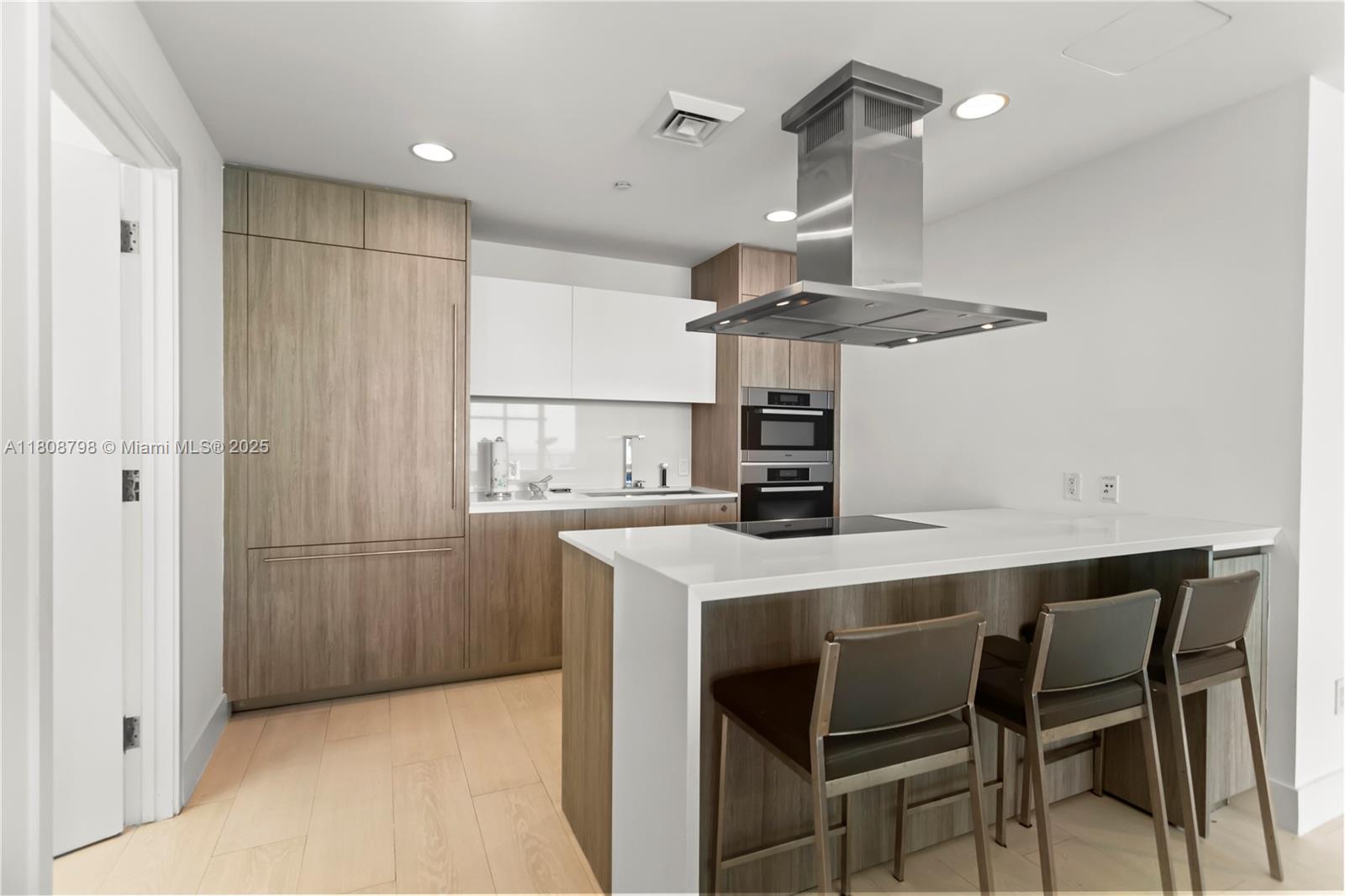 350 Ocean Drive, Unit 904N Key Biscayne, FL 33149 - Photo 29 of 41 a kitchen with stainless steel appliances a table and chairs in it