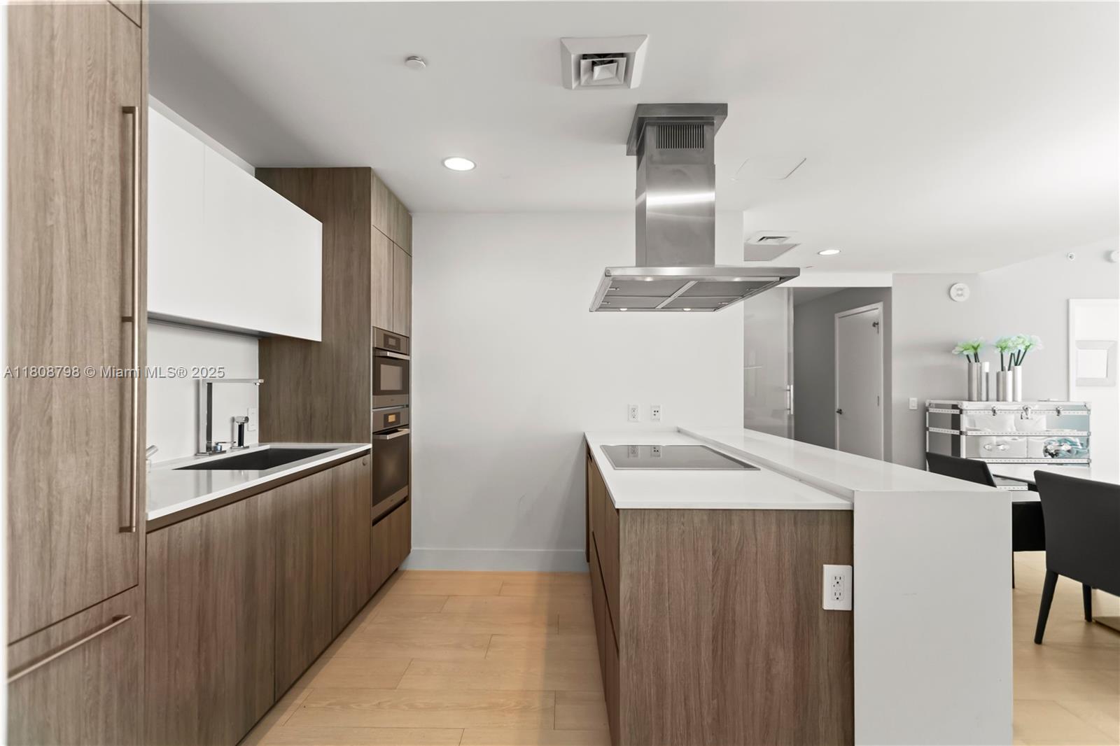 350 Ocean Drive, Unit 904N Key Biscayne, FL 33149 - Photo 30 of 41 a kitchen with stainless steel appliances kitchen island a sink stove and refrigerator