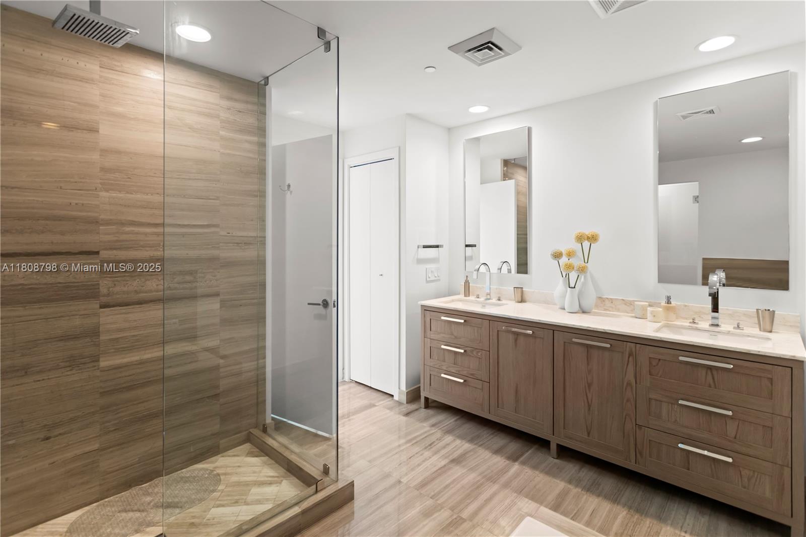 350 Ocean Drive, Unit 904N Key Biscayne, FL 33149 - Photo 33 of 41 a spacious bathroom with double vanity and a shower