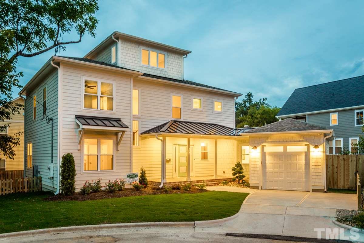 a front view of a house with a yard and outdoor seating