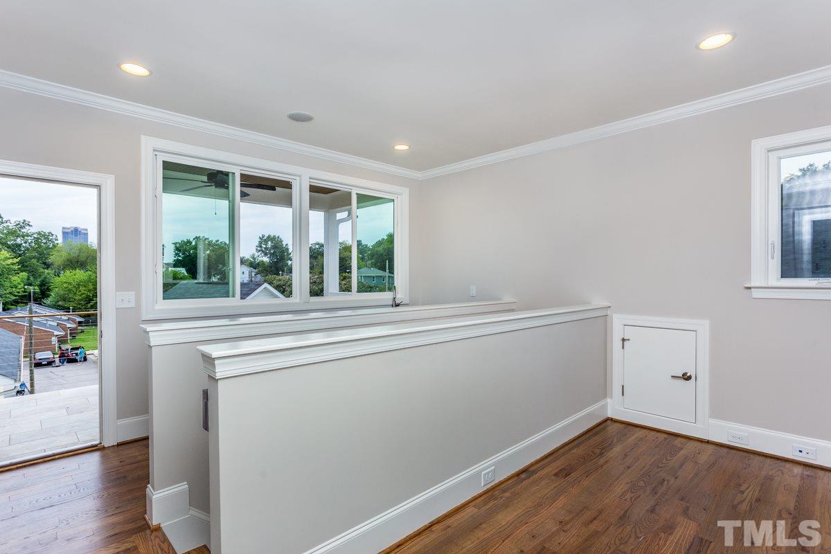 208 Bladen Street Raleigh, NC 27601 - Photo 22 of 25 an empty room with wooden floor and windows