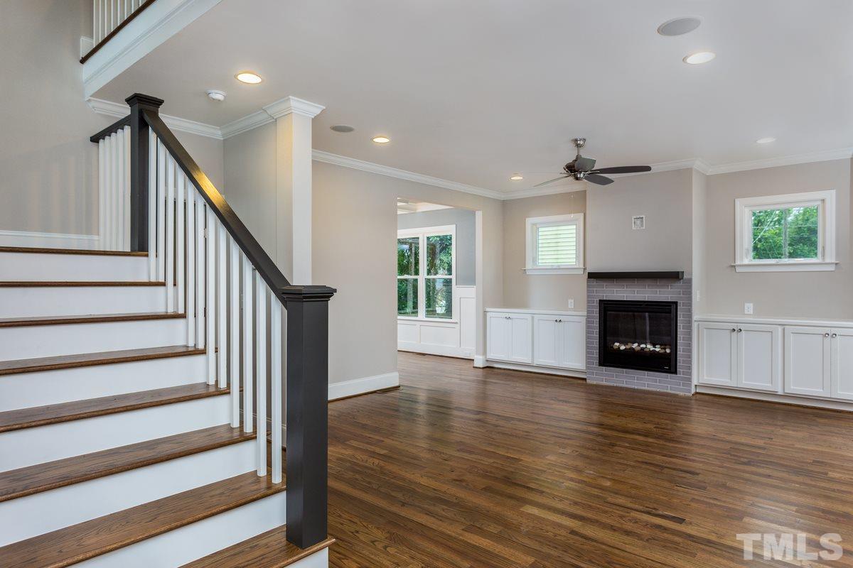 208 Bladen Street Raleigh, NC 27601 - Photo 4 of 25 a view of a livingroom with wooden floor and a fireplace