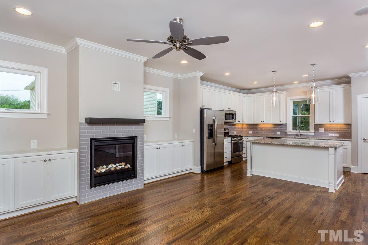 208 Bladen Street Raleigh, NC 27601 - Photo 5 of 25 a open kitchen with stainless steel appliances granite countertop a refrigerator stove top oven and cabinets