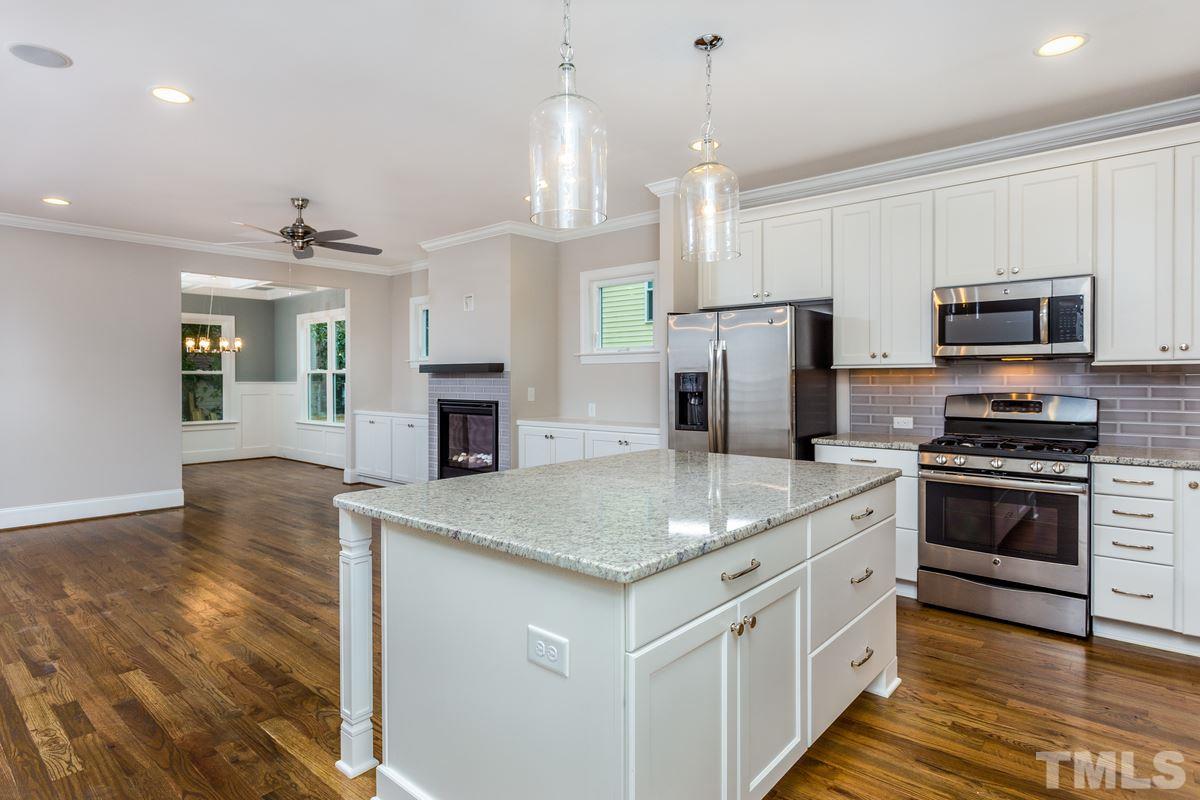 208 Bladen Street Raleigh, NC 27601 - Photo 8 of 25 a kitchen with stainless steel appliances granite countertop a sink stove and refrigerator