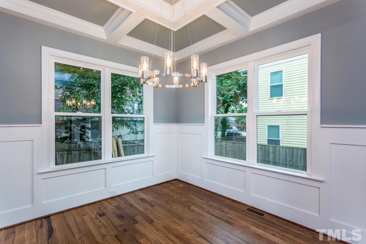 208 Bladen Street Raleigh, NC 27601 - Photo 9 of 25 a view of an empty room with wooden floor and a window