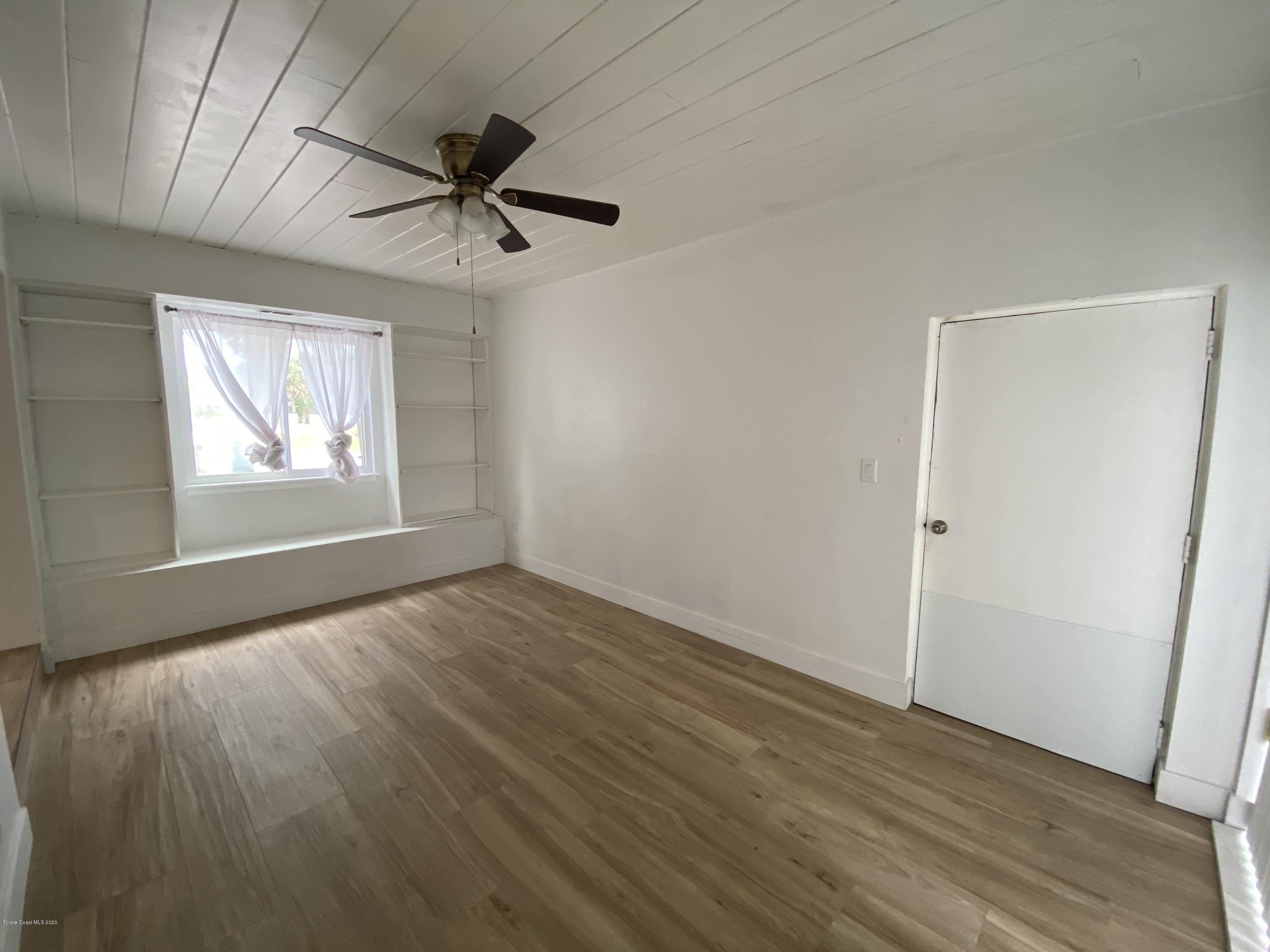 2309 Country Club Road Melbourne, FL 32901 - Photo 12 of 50 wooden floor in an empty room with a window