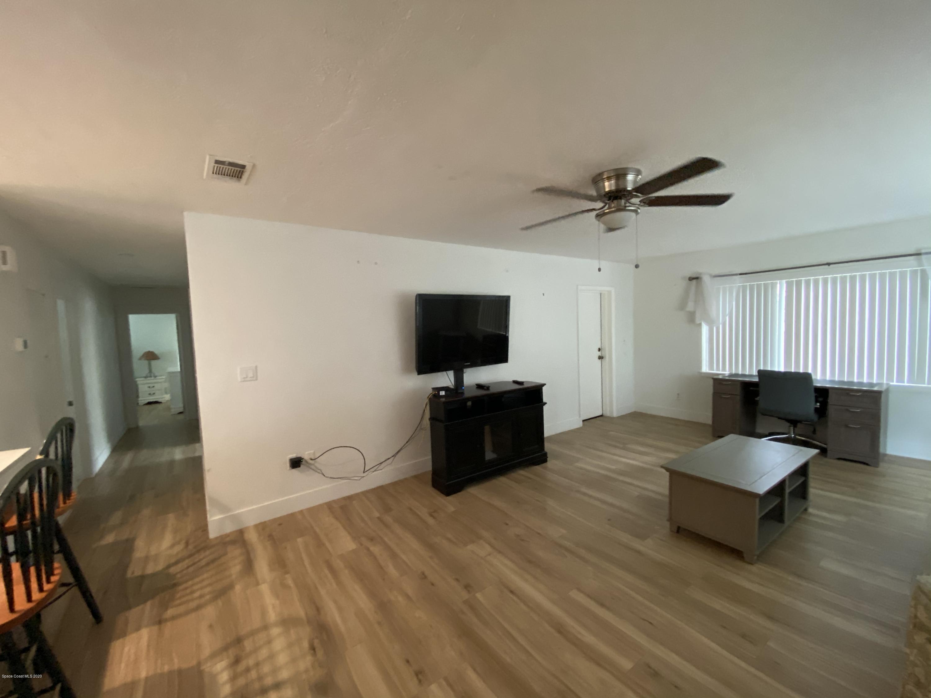 2309 Country Club Road Melbourne, FL 32901 - Photo 13 of 50 a living room with furniture and a flat screen tv