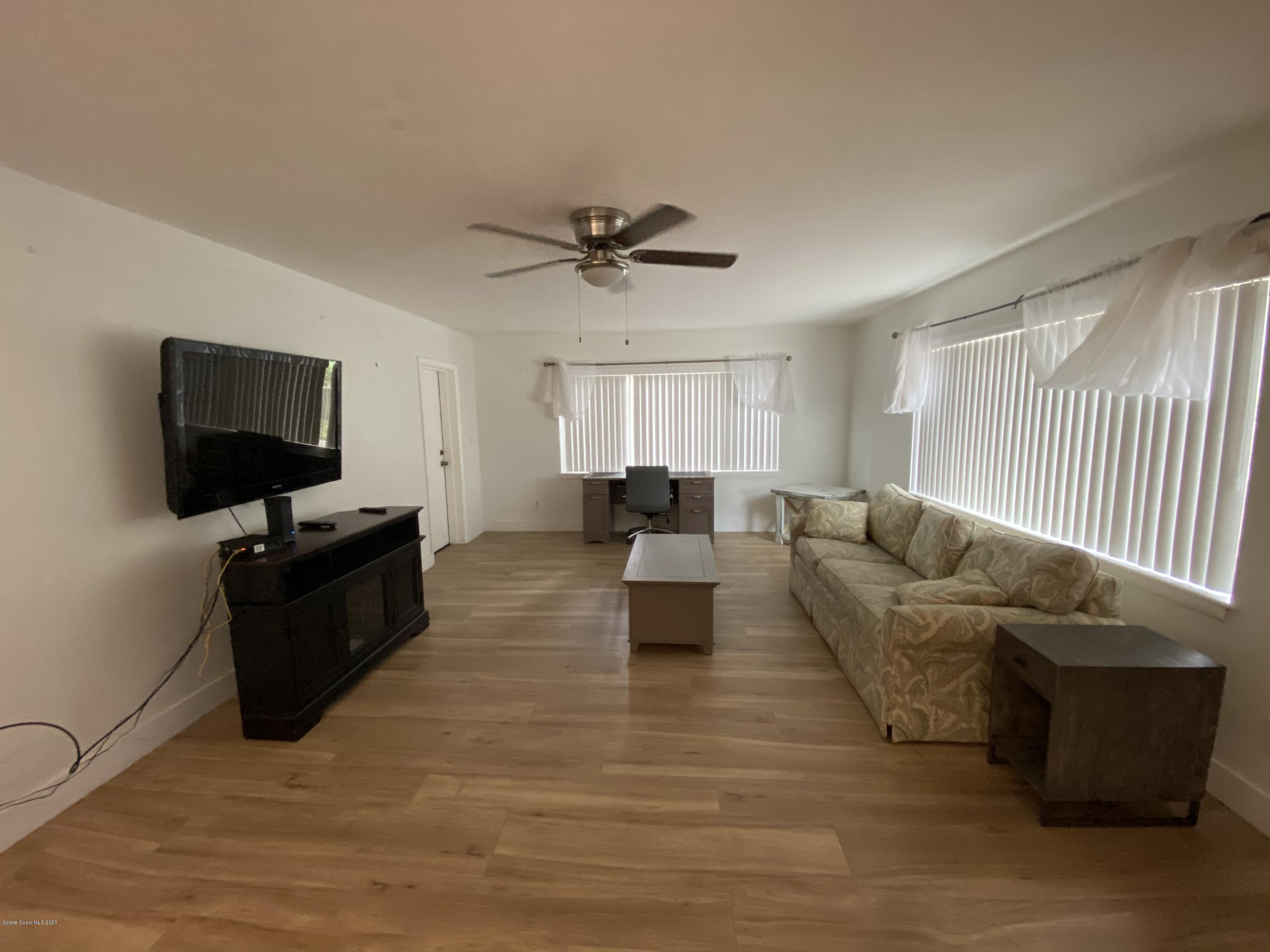 2309 Country Club Road Melbourne, FL 32901 - Photo 14 of 50 a living room with furniture and a flat screen tv