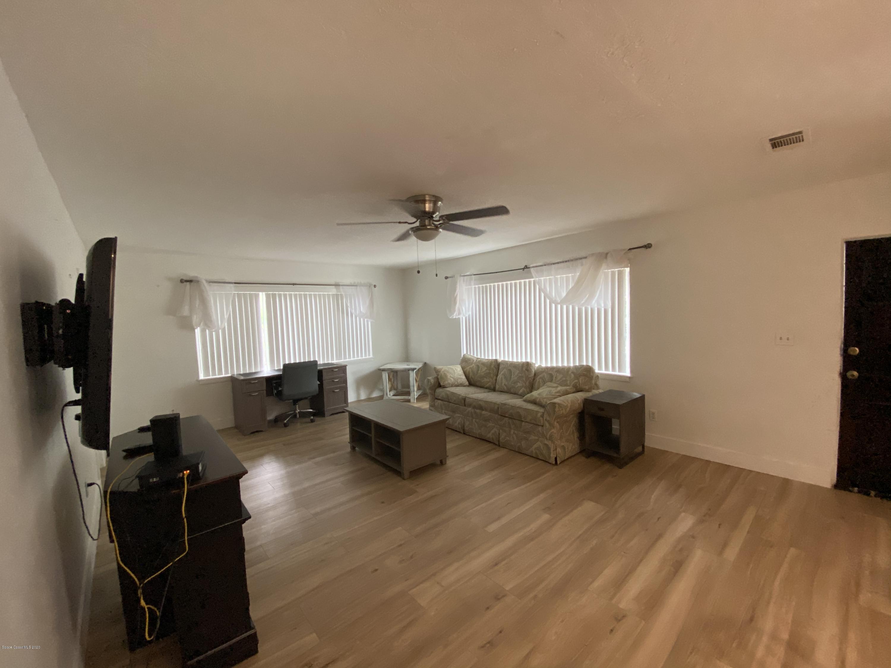 2309 Country Club Road Melbourne, FL 32901 - Photo 15 of 50 a living room with furniture and a flat screen tv