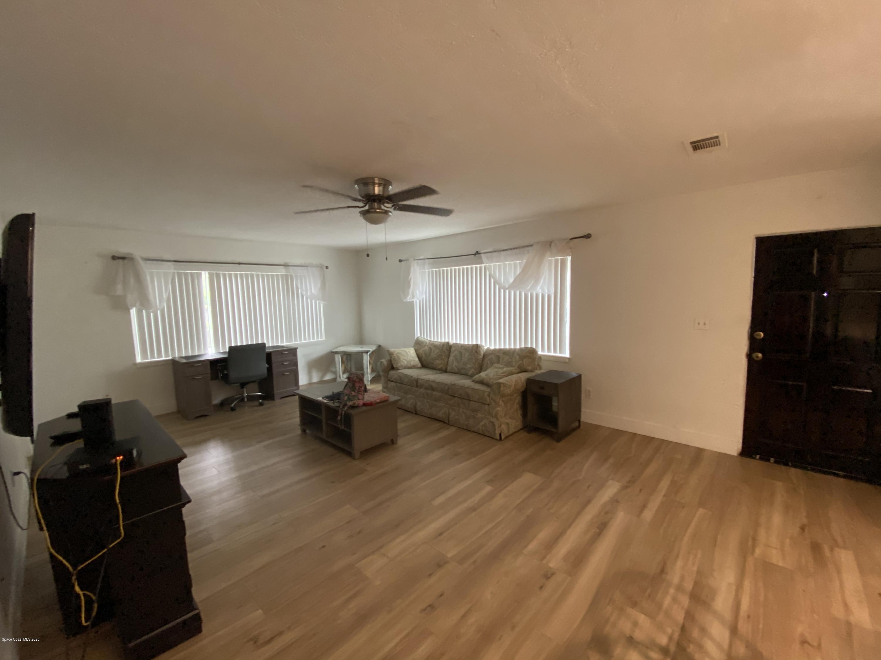 2309 Country Club Road Melbourne, FL 32901 - Photo 16 of 50 a living room with furniture and a flat screen tv