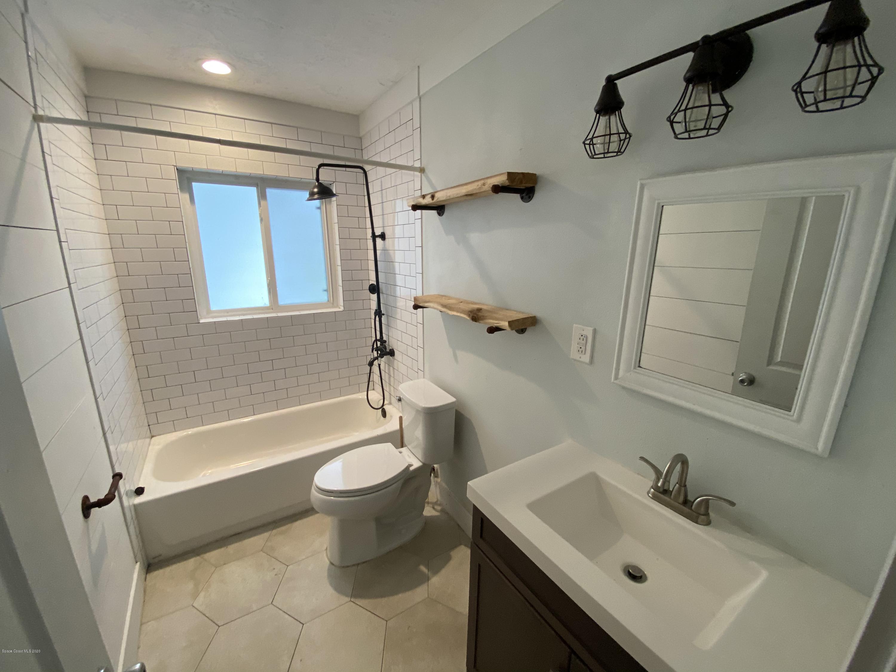 2309 Country Club Road Melbourne, FL 32901 - Photo 18 of 50 a bathroom with a sink toilet and shower