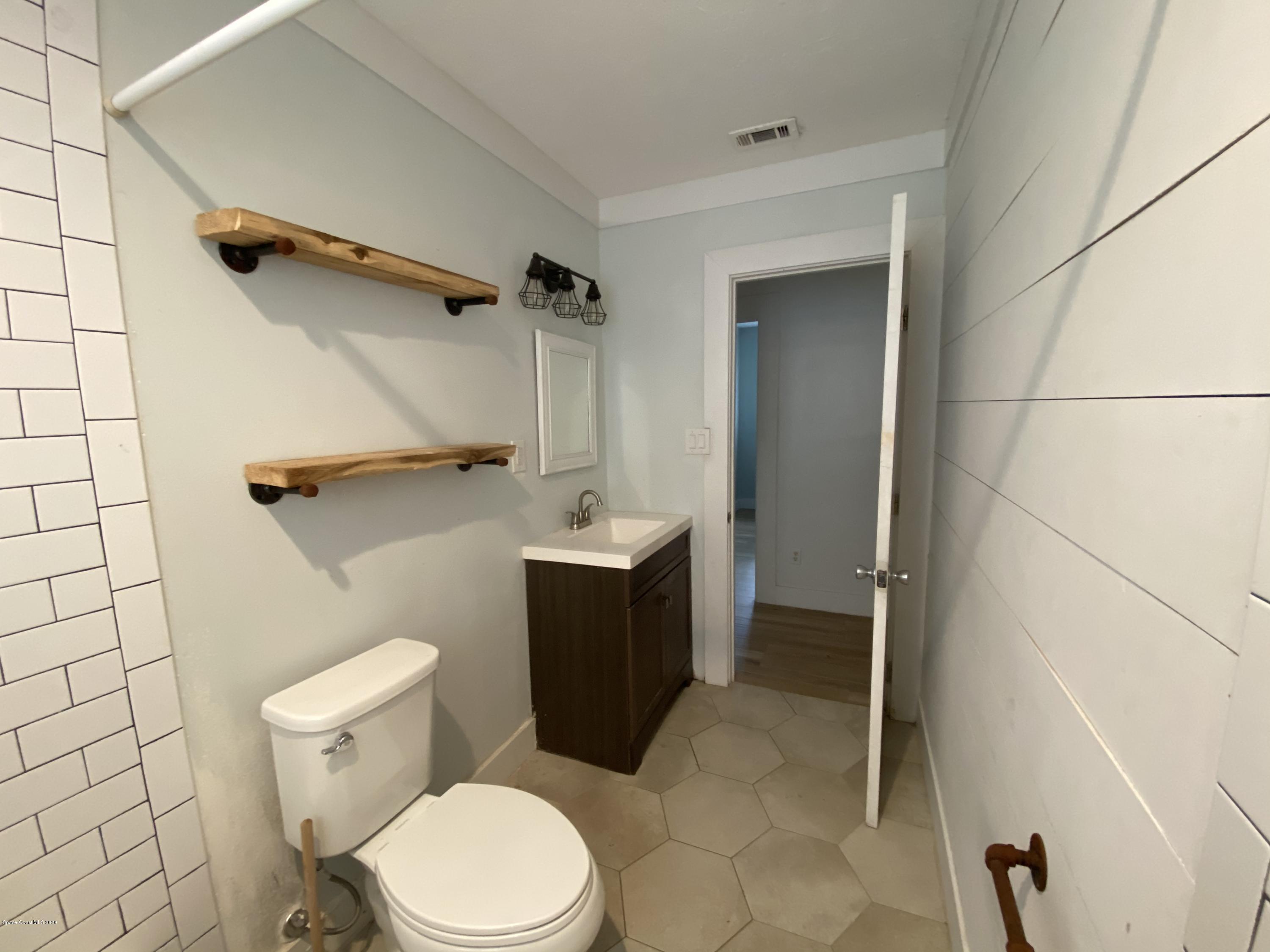 2309 Country Club Road Melbourne, FL 32901 - Photo 19 of 50 a bathroom with a toilet and a shower