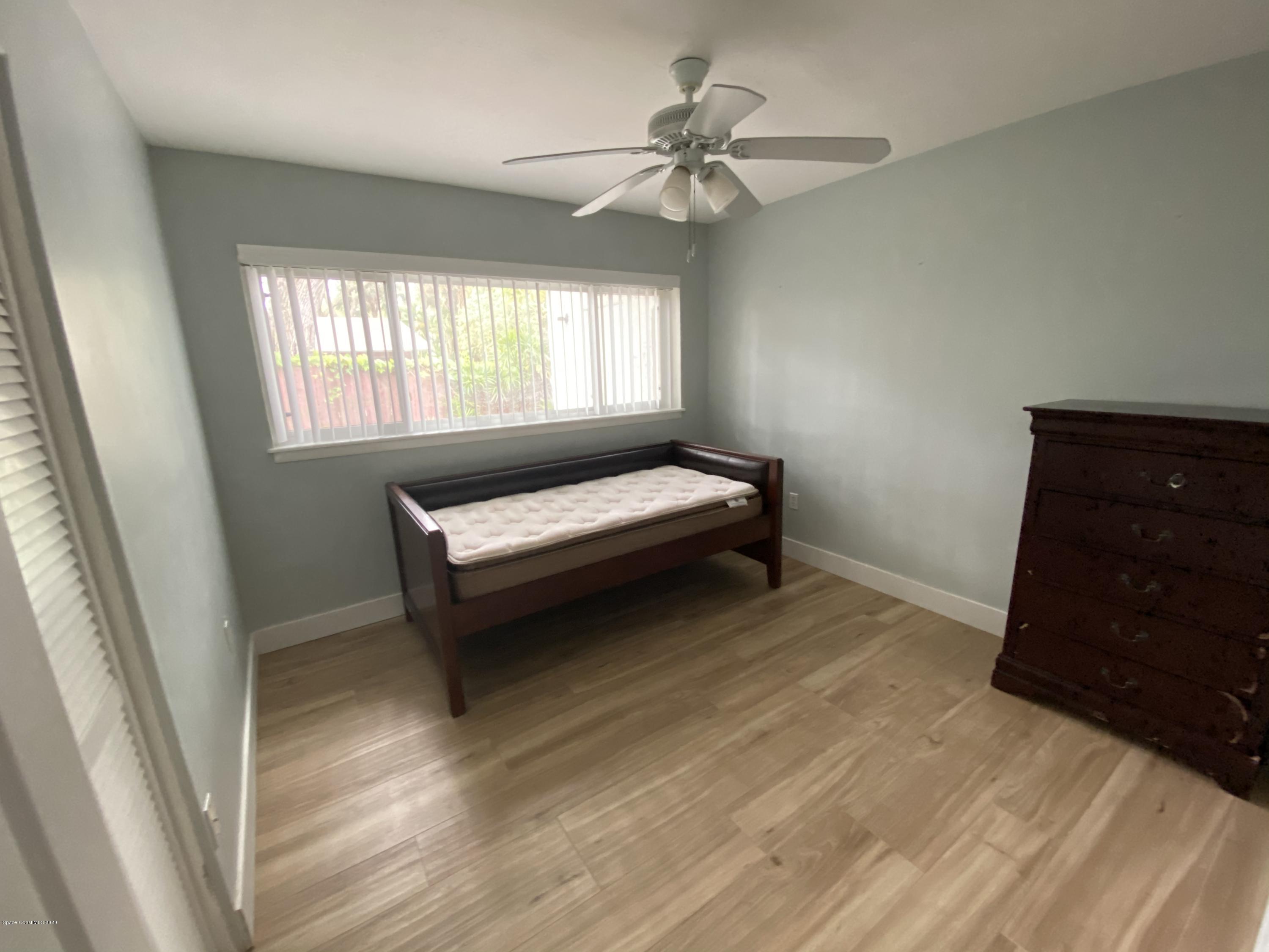 2309 Country Club Road Melbourne, FL 32901 - Photo 21 of 50 a bedroom with a bed and a dresser