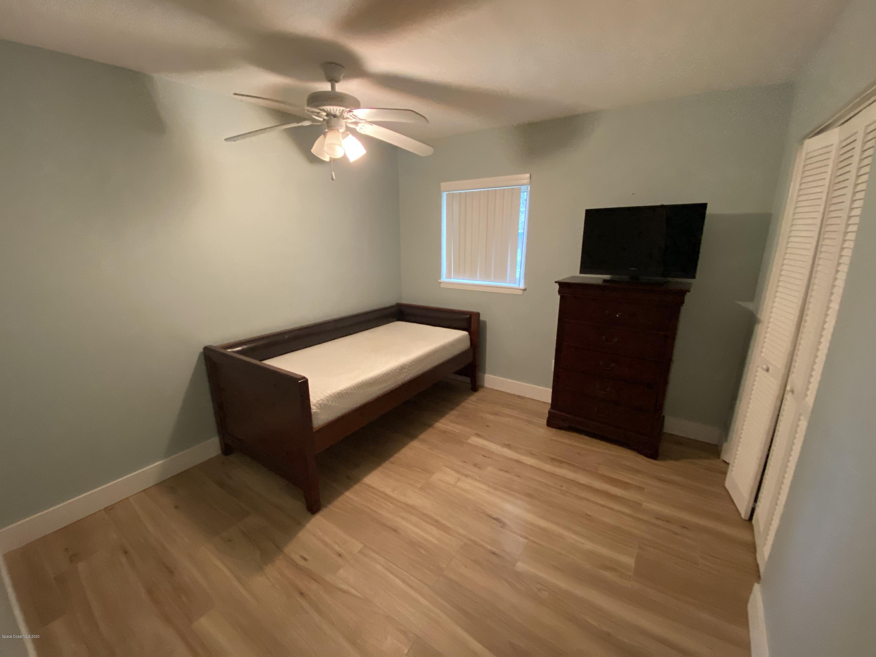 2309 Country Club Road Melbourne, FL 32901 - Photo 25 of 50 a living room with furniture and a flat screen tv