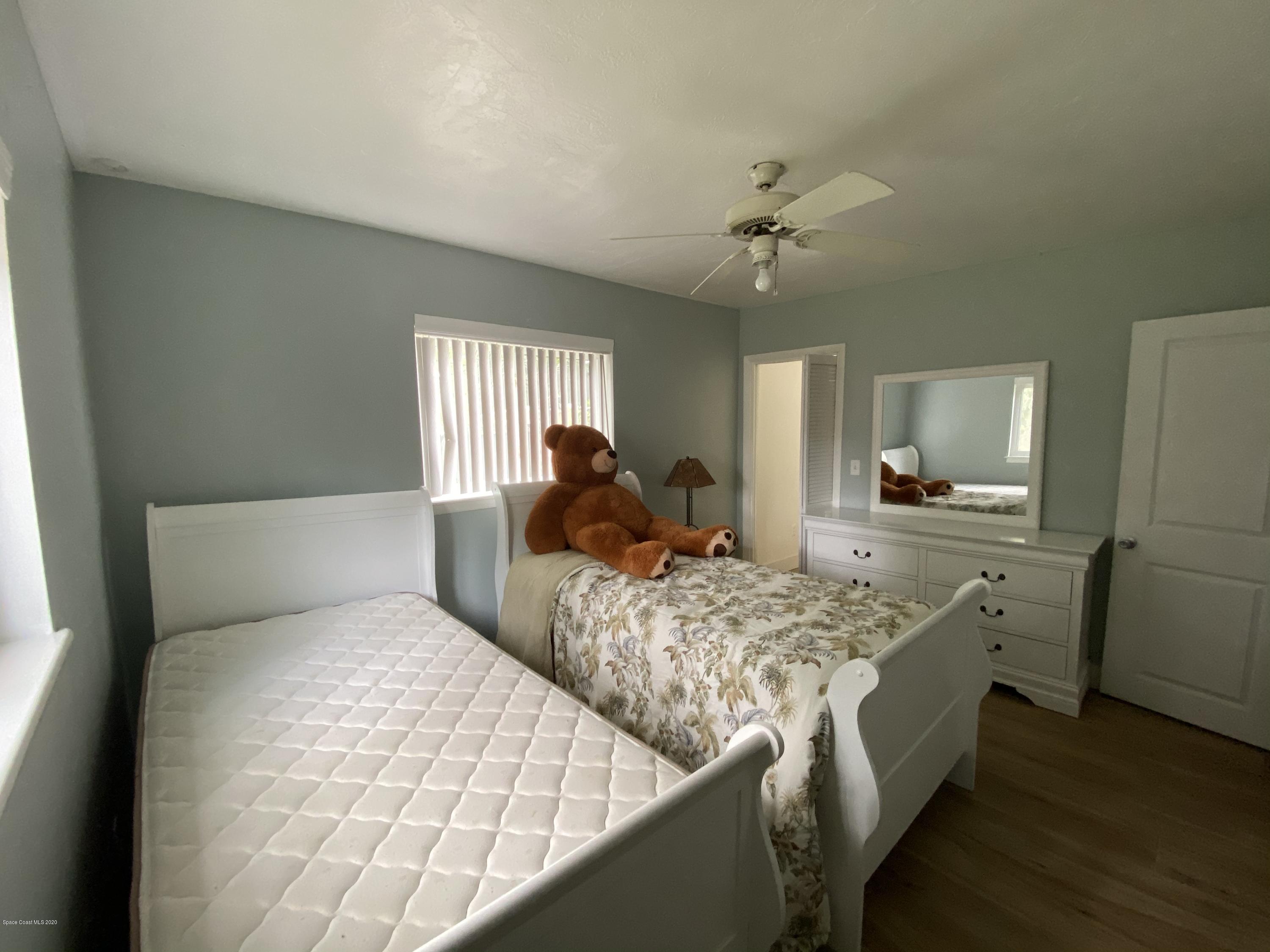 2309 Country Club Road Melbourne, FL 32901 - Photo 30 of 50 a bedroom with two beds and a refrigerator