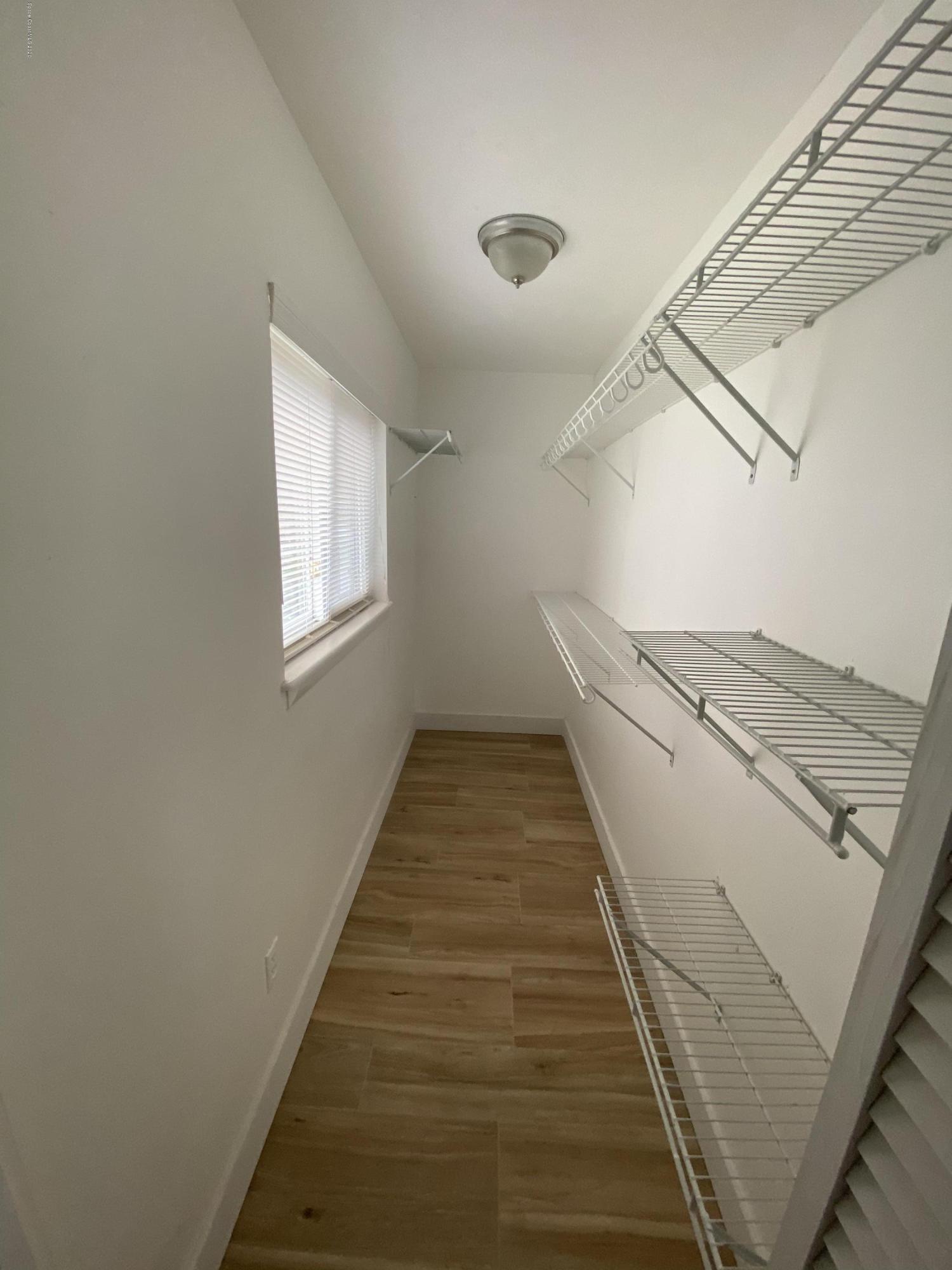 2309 Country Club Road Melbourne, FL 32901 - Photo 31 of 50 a view of a hallway with wooden floor and staircase