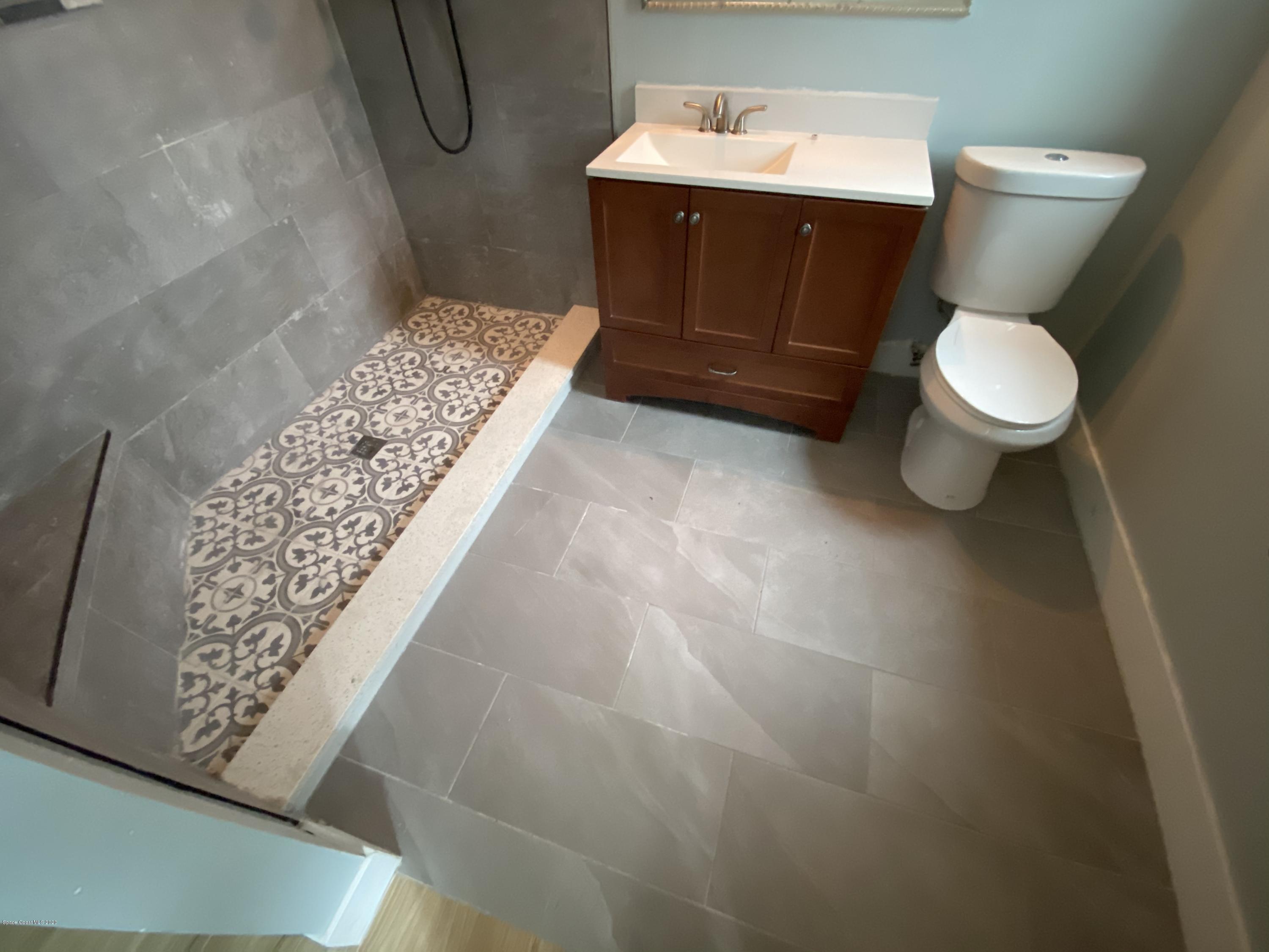 2309 Country Club Road Melbourne, FL 32901 - Photo 34 of 50 a bathroom with a sink and a toilet