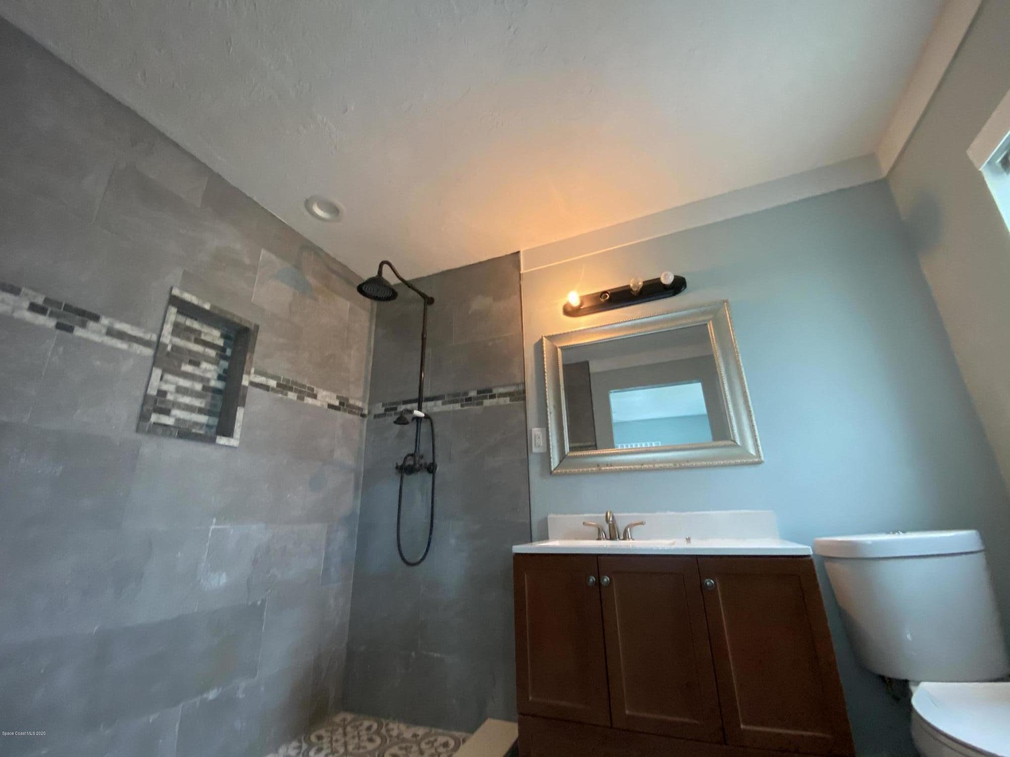 2309 Country Club Road Melbourne, FL 32901 - Photo 35 of 50 a bathroom with a sink toilet and shower