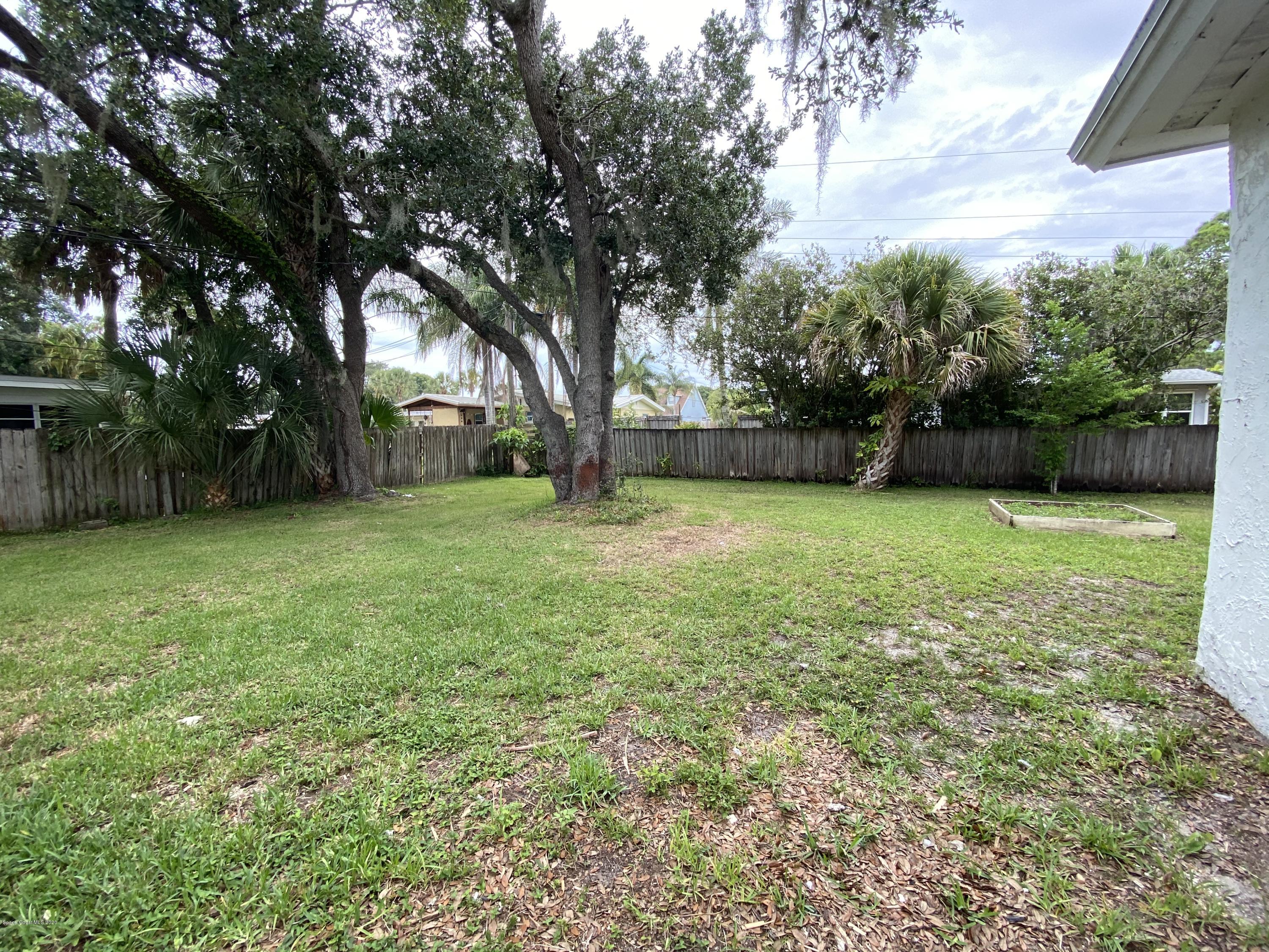 2309 Country Club Road Melbourne, FL 32901 - Photo 41 of 50 a view of a yard with a house in the background