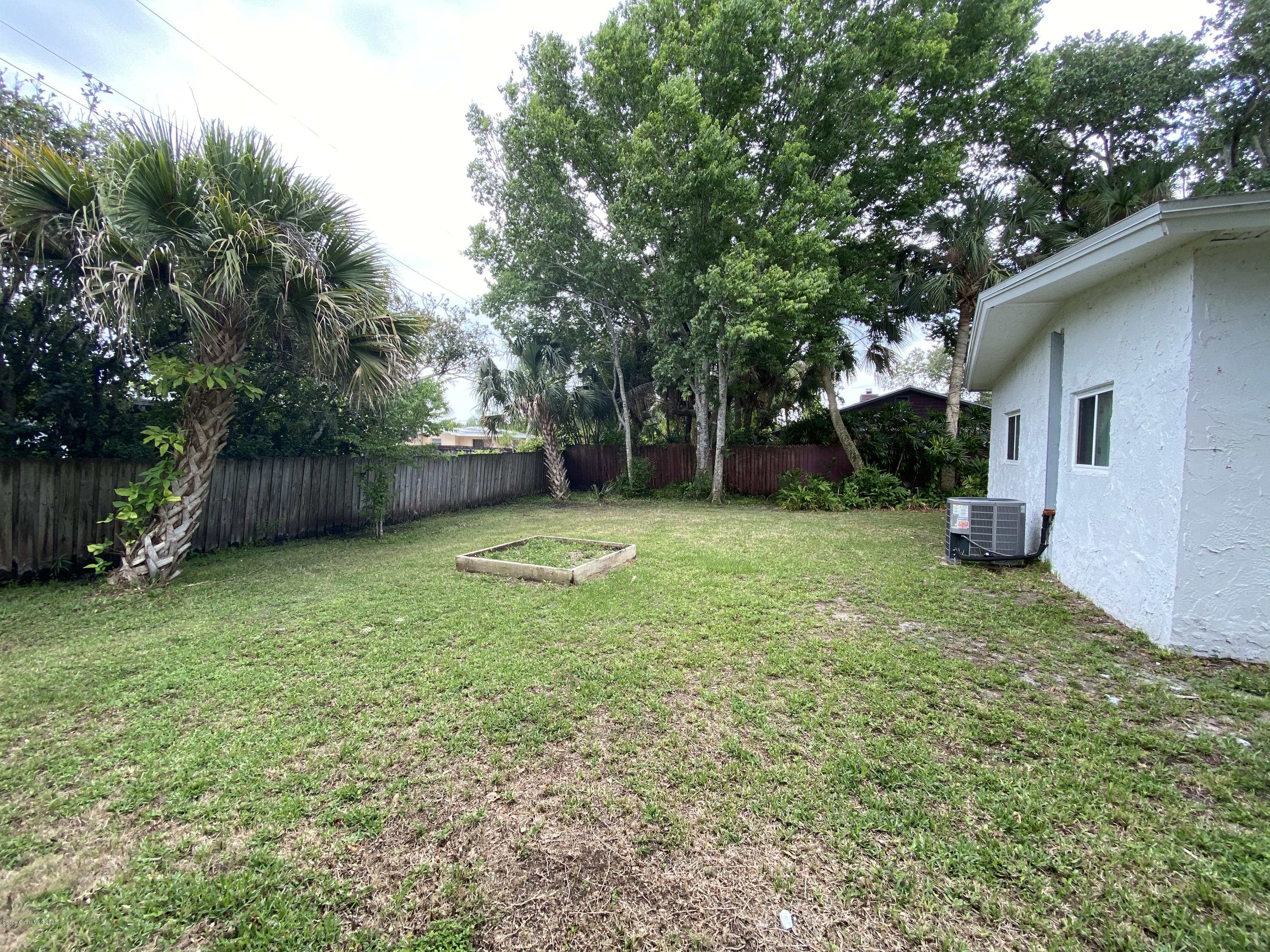 2309 Country Club Road Melbourne, FL 32901 - Photo 42 of 50 a view of a backyard with a small cabin