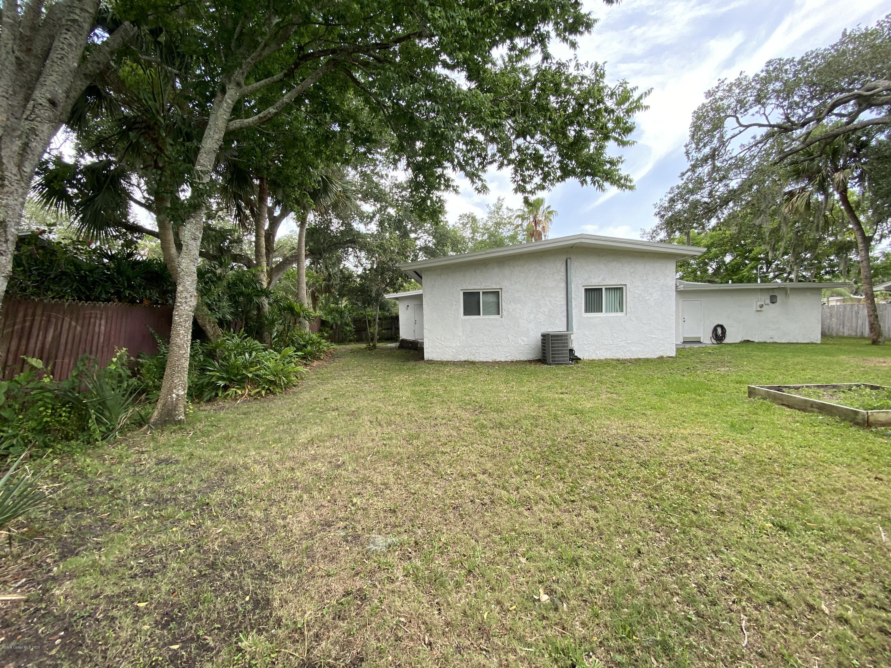 2309 Country Club Road Melbourne, FL 32901 - Photo 43 of 50 a white house that has a tree in front of it