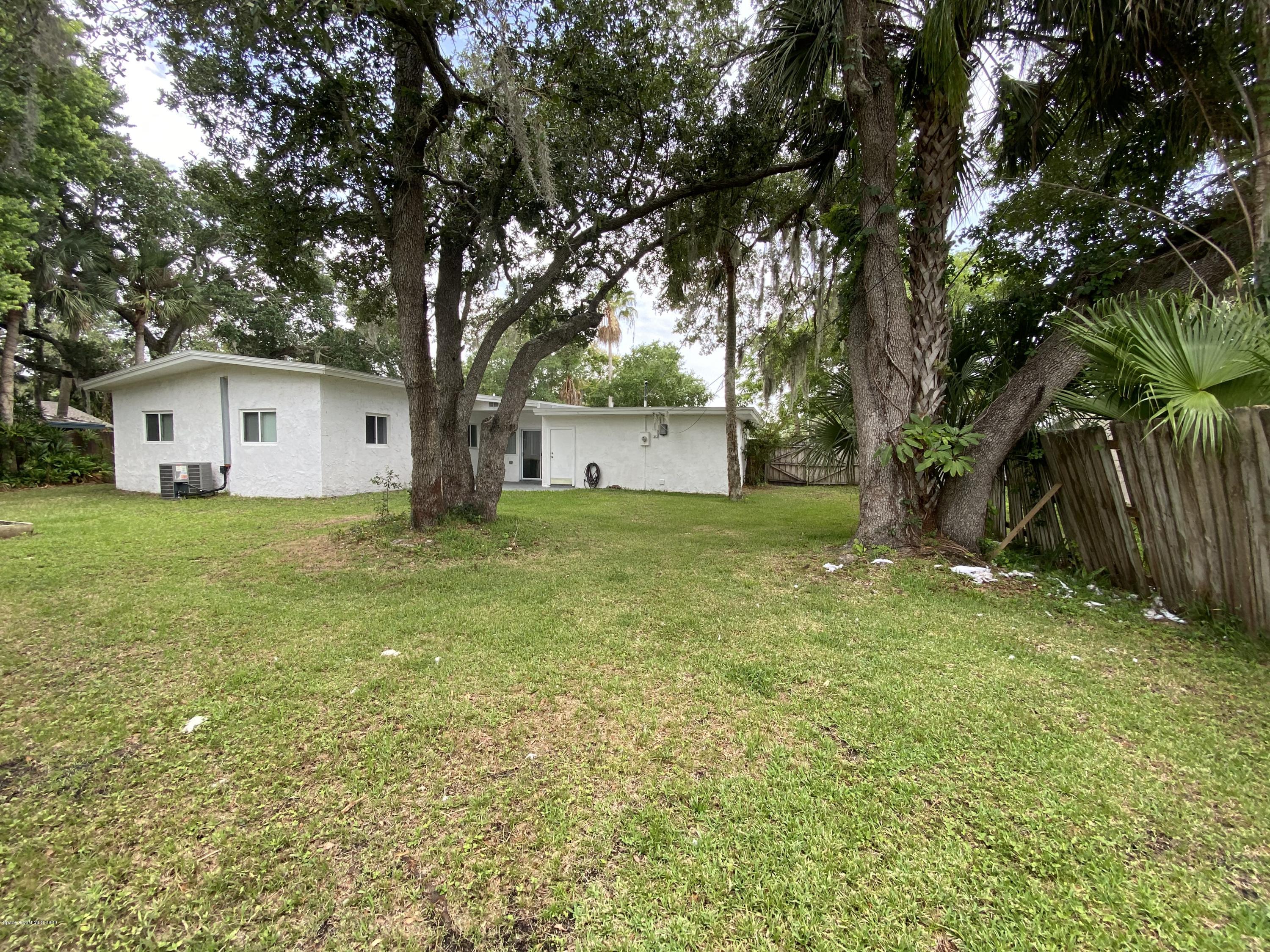 2309 Country Club Road Melbourne, FL 32901 - Photo 47 of 50 a white house that has a tree in front of it