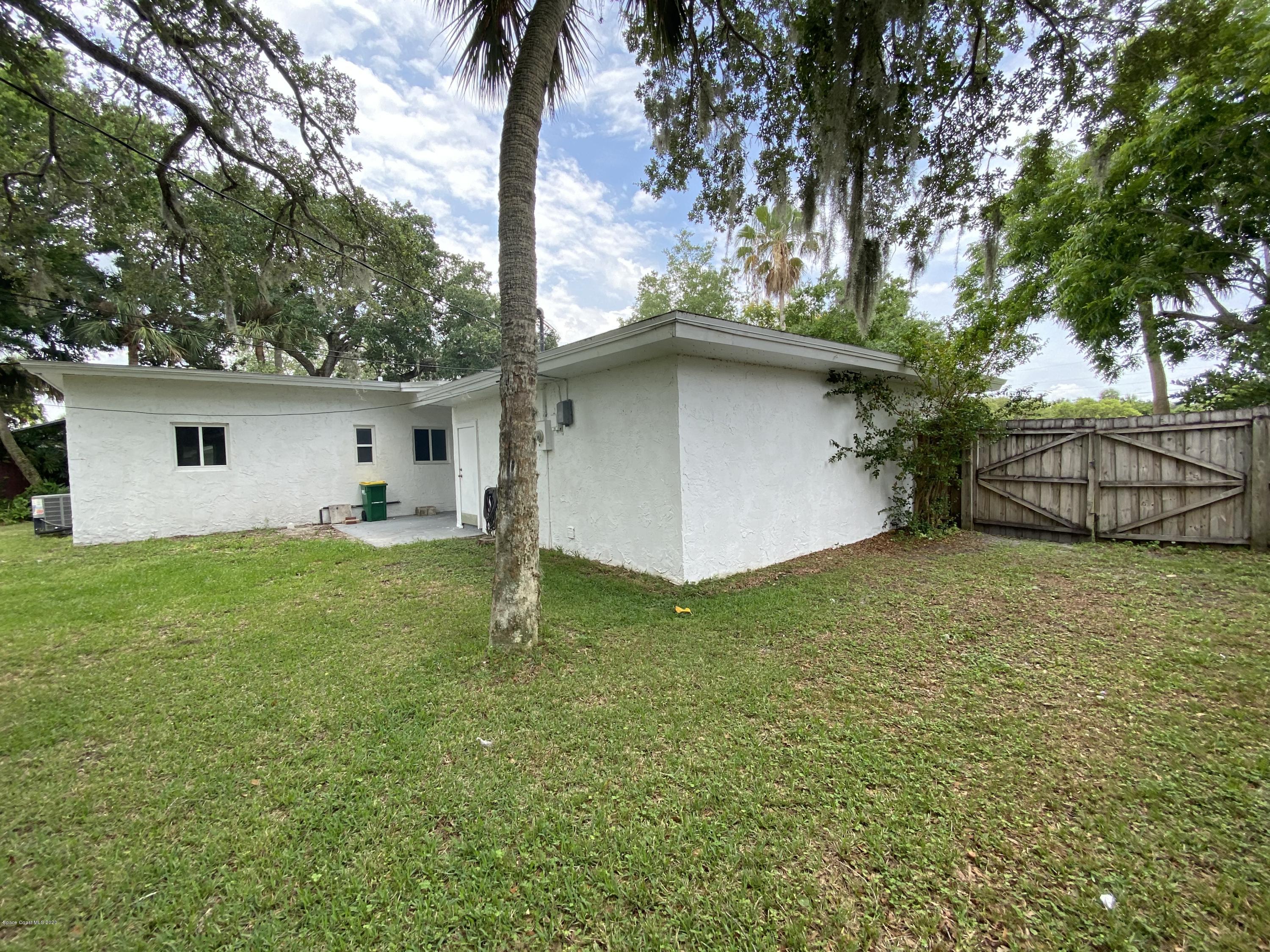 2309 Country Club Road Melbourne, FL 32901 - Photo 48 of 50 a view of a backyard with a tree