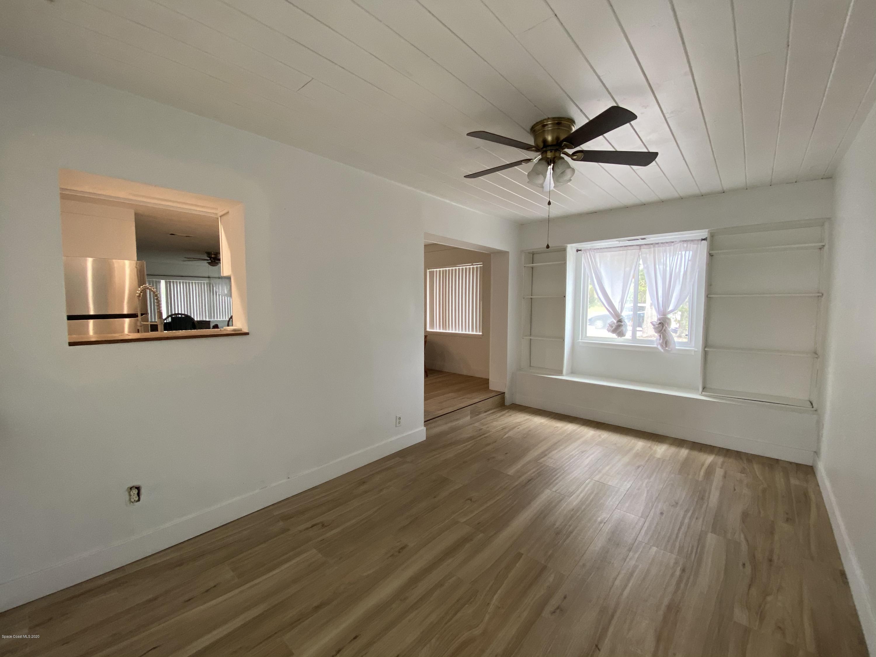 2309 Country Club Road Melbourne, FL 32901 - Photo 10 of 50 wooden floor in an empty room with a window