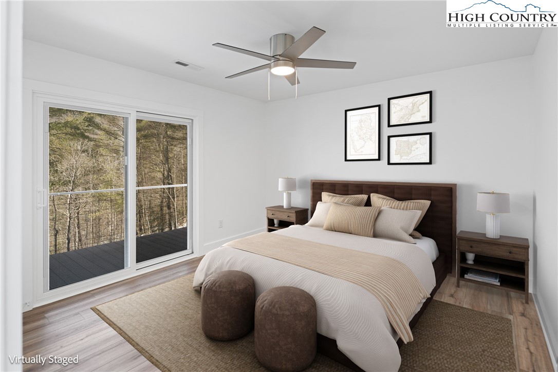 114 Woodpecker Road Purlear, NC 28665 - Photo 6 of 47 a bedroom with a large bed and a large window