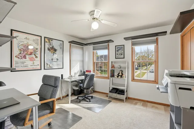 a view of a workspace with furniture and a window