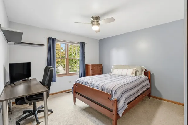 a bedroom with a bed a table and chair