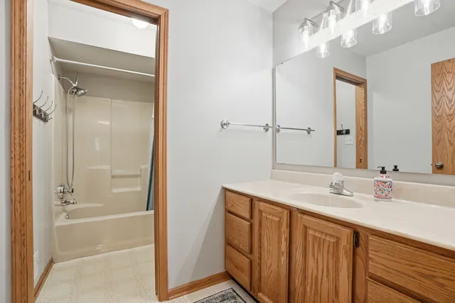 a bathroom with a sink a mirror and a shower