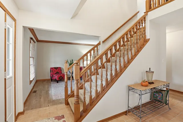 a view of entryway with wooden floor and stairs