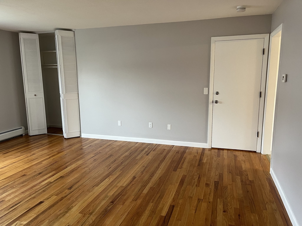 114 Colonial Circle, Unit C Chicopee, MA 01020 - Photo 6 of 16 a view of an empty room with wooden floor