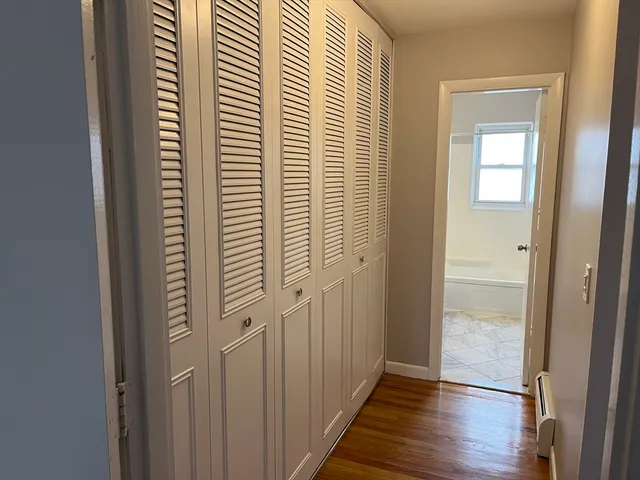 a view of a hallway with wooden floor