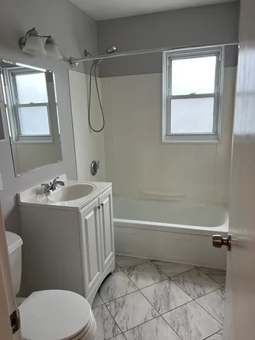 a bathroom with a sink a toilet and a bathtub