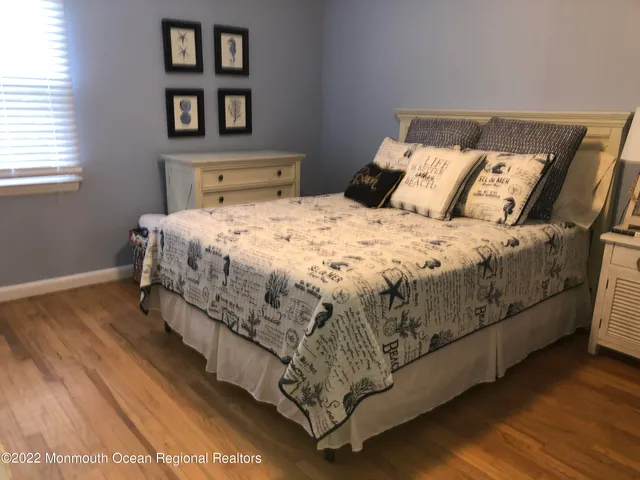 a bedroom with a bed and a night stand