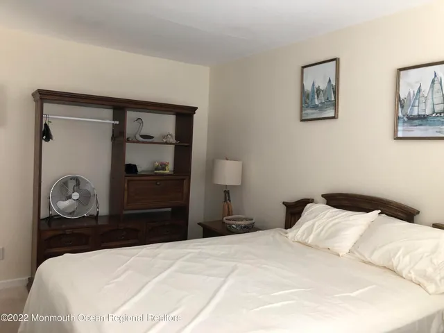 a bedroom with a bed and a mirror