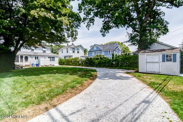 a front view of a house with yard and green space