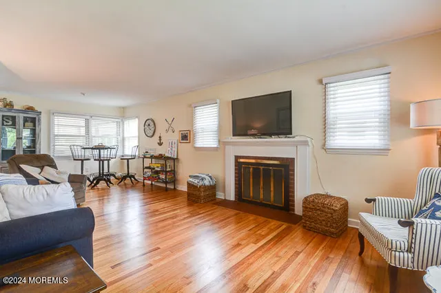 a living room with furniture fireplace and a window