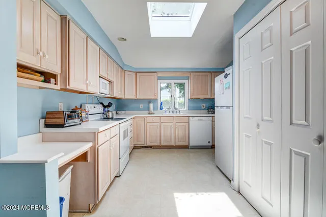 a kitchen with stainless steel appliances sink a microwave and cabinets