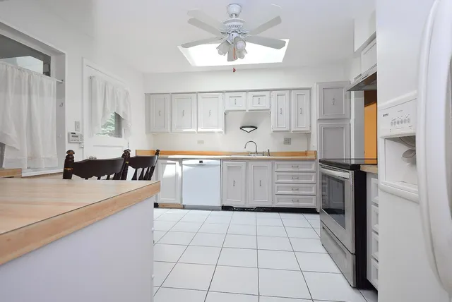 a kitchen with a sink a stove cabinets and counter space