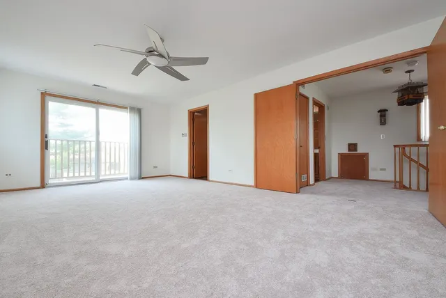 a view of a livingroom with a ceiling fan and window