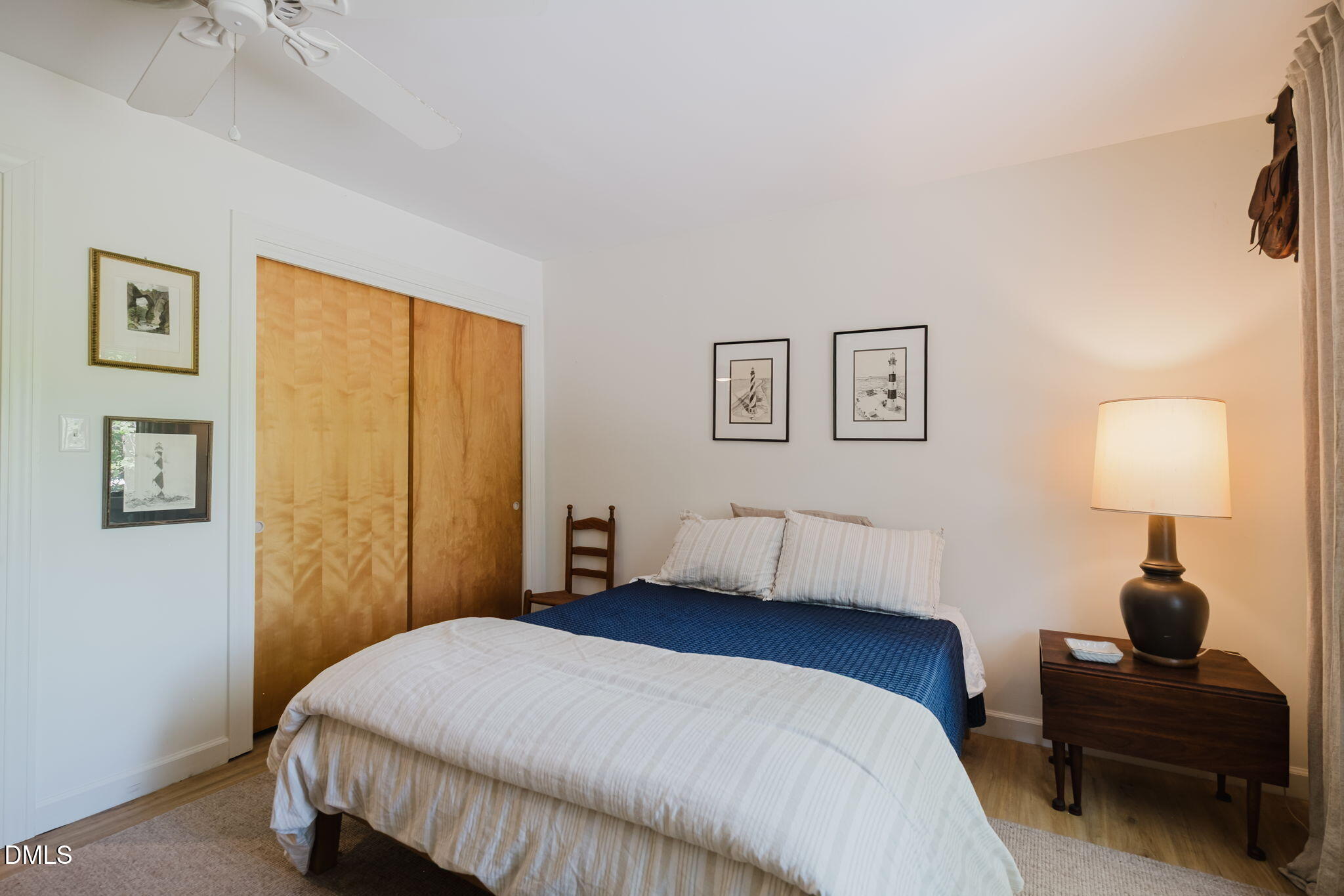 370 Robinson Ferry Road Macon, NC 27551 - Photo 44 of 85 a bedroom with a bed and a lamp