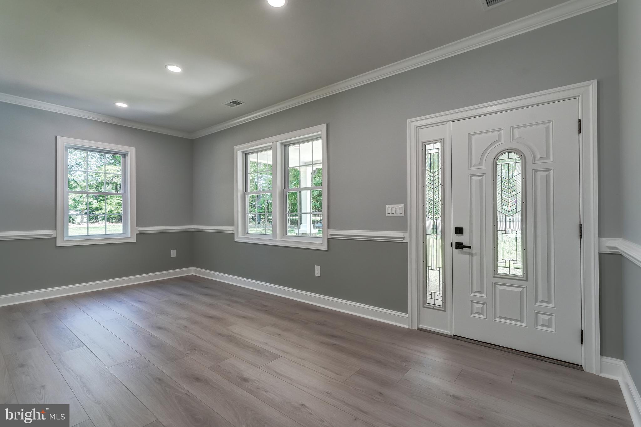 50 Retriever Court Bumpass, VA 23024 - Photo 17 of 77 an empty room with wooden floor and windows