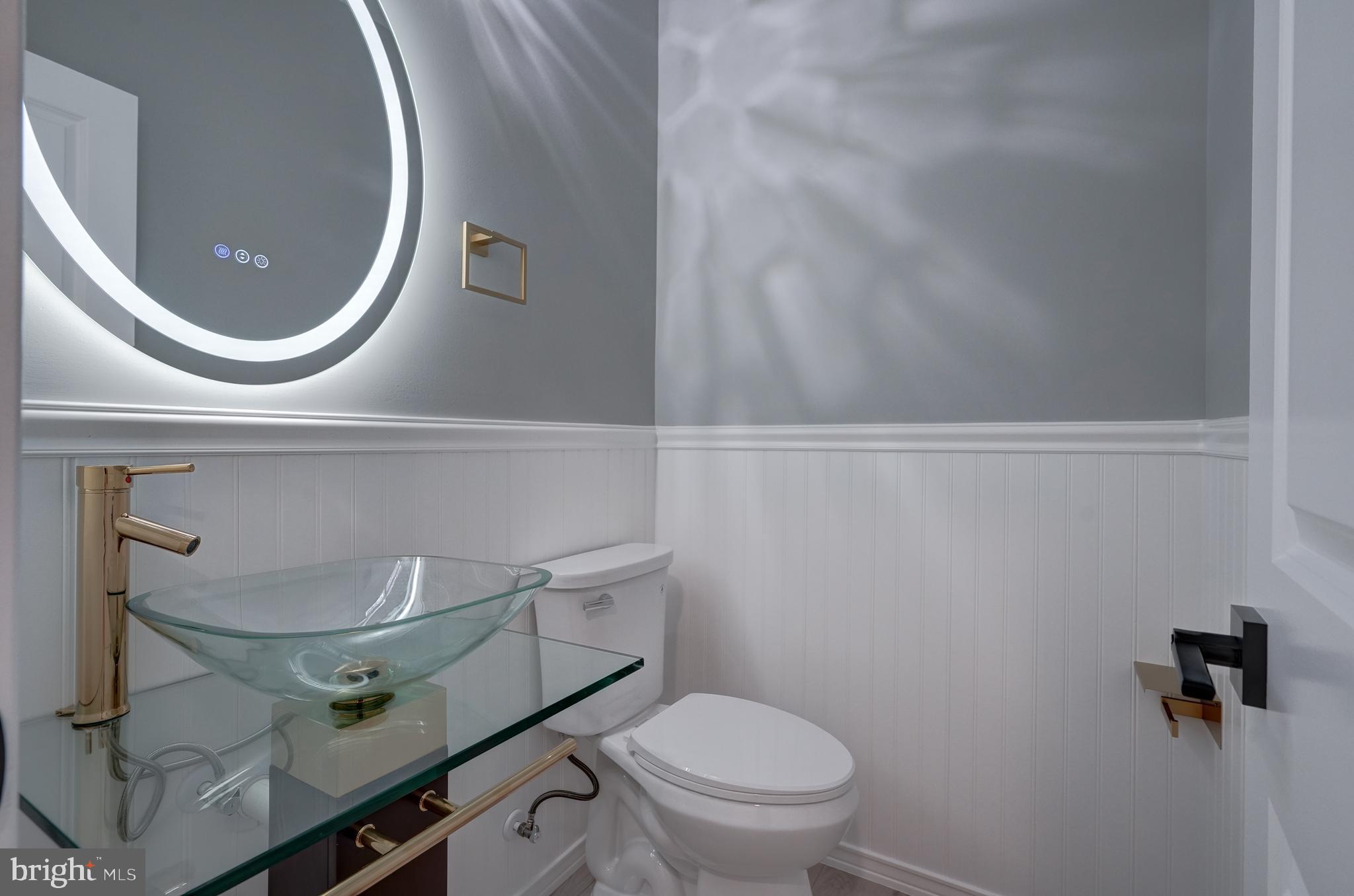 50 Retriever Court Bumpass, VA 23024 - Photo 22 of 77 a bathroom with a sink mirror and toilet